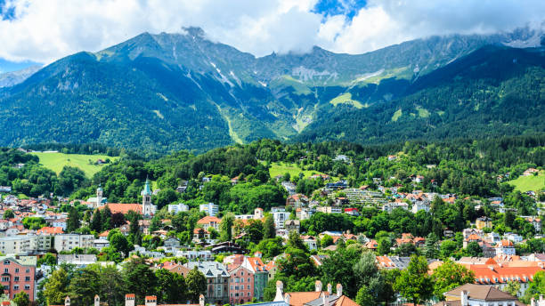 Cityscape of Innsbruck in Austria Innsbruck is the capital city of Tyrol in western Austria, located in the Inn Valley. It is an internationally renowned winter sports centre. inn river stock pictures, royalty-free photos & images