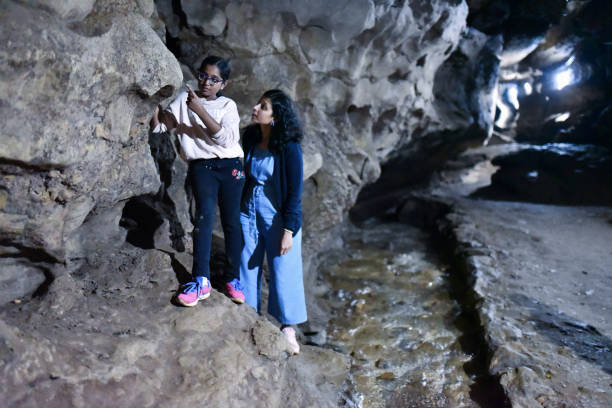 istock Mother and daughter exploring the cave 1191250965