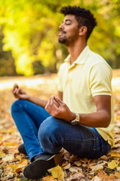 istock Young man meditating in nature on autumn day. 1191250985