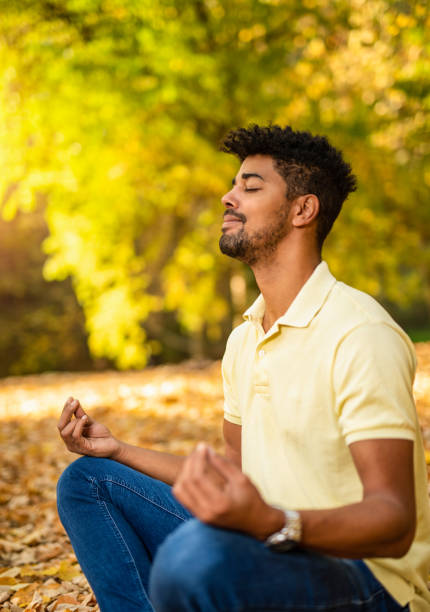 istock Young man meditating in nature on autumn day. 1191251501