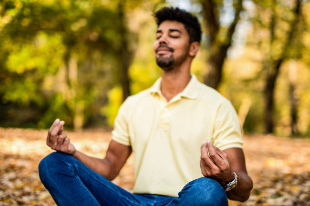 istock Young man meditating in nature on autumn day. 1191251576