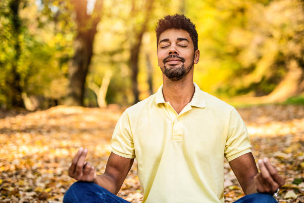 istock Young man meditating in nature on autumn day. 1191251599