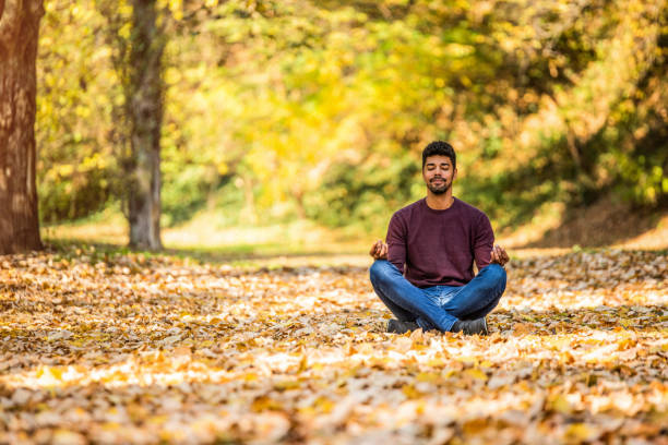 istock Young man meditating in nature on autumn day. 1191251649