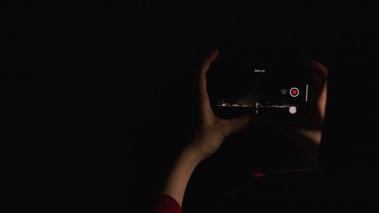 4K Slow motion New year festival Asian women She is using a mobile phone to photograph fireworks during the end of the year celebration.