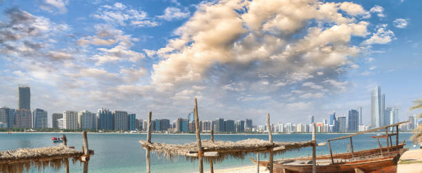 istock Panoramic view of Abu Dhabi Downtown skyline from the beach at sunset, UAE 1191255842