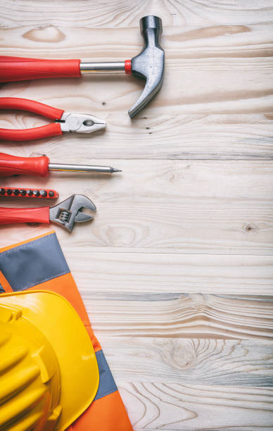 istock Tools, hardhat on wooden desk, top view. 1191255993