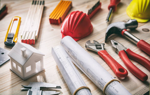 istock Tools, hardhats and project plans on wooden desk 1191256055