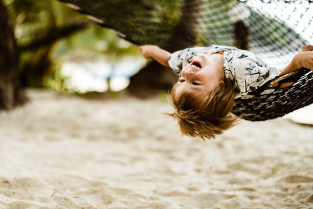istock Playful little boy having fun in hammock on the beach. 1191256722