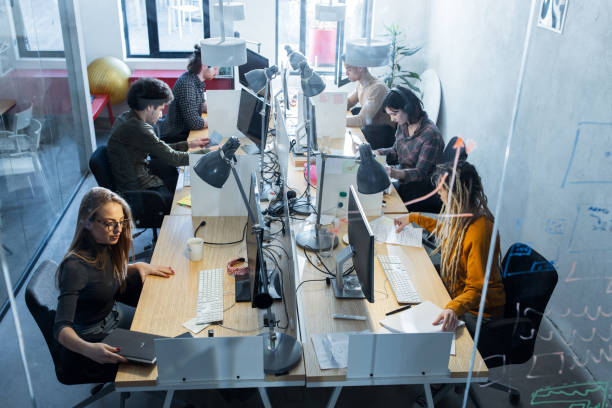 istock Above view of multi-ethnic programmers working at corporate office. 1191261638