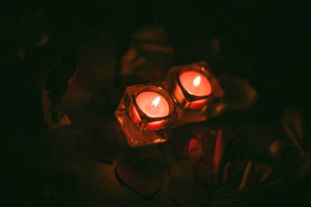 istock two burning candles on a dark background 1191261654