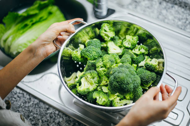 istock Woman holding broccoli 1191262591