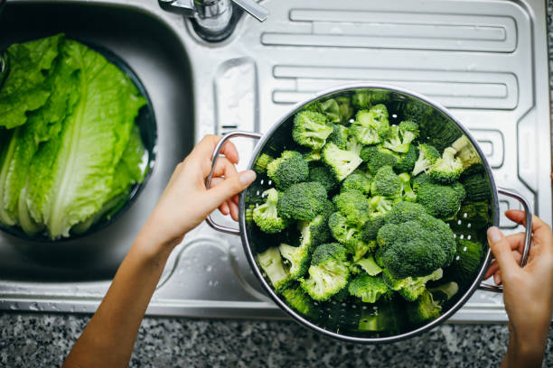 istock Woman holding broccoli 1191262625