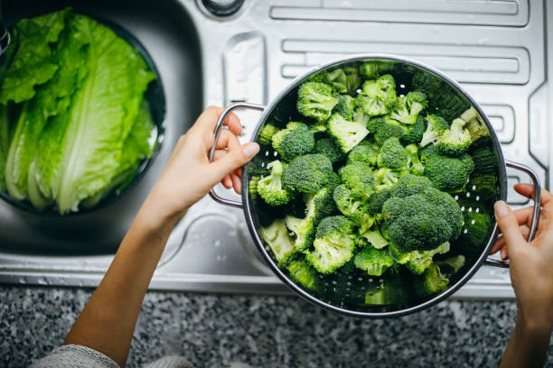 istock Woman holding broccoli 1191262628