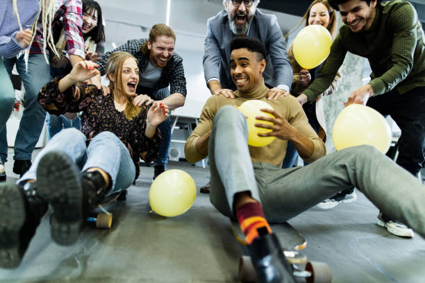 istock Cheerful freelancers having fun during skateboard competition at casual office. 1191262801