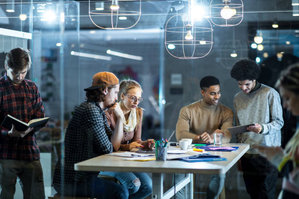 istock Large group of multi-tasking freelancers working in the office. 1191263131