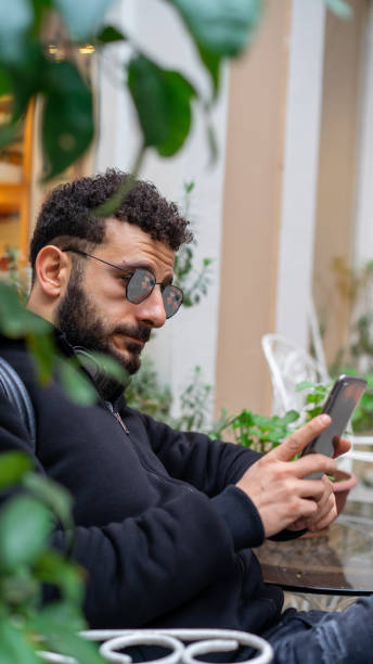istock man sitting with sunglasses 1191265494