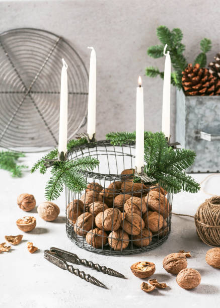 istock Rustic Christmas advent wreath with white candles, green fir branches and walnuts. 1. Advent. 1191265924