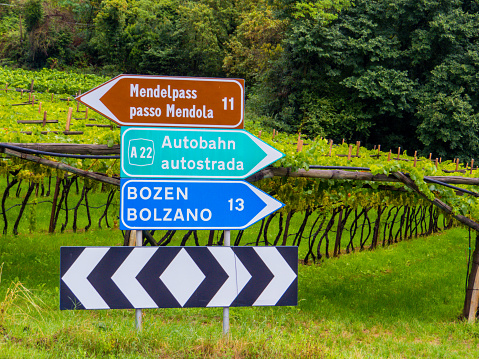 Bilingual signs (German above, Italian below) near Bolzano, Trentino-Alto Adige, Dolomites, north Italy