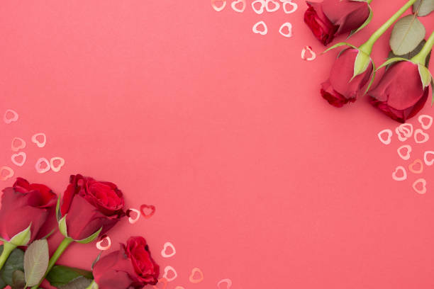 istock Red roses over red background flat lay. Valentine's Day, Birthday abstract background with copy space. 1191267111