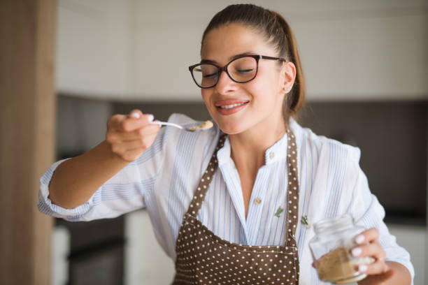 istock Young woman in kitchen preparing lunch 1191267295