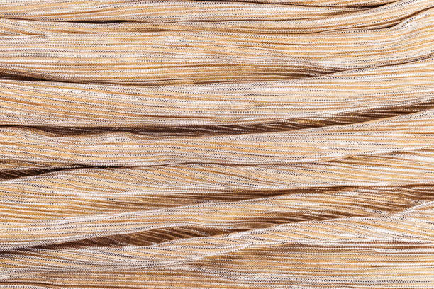 istock Golden shiny striped fabric, abstract background. 1191268165