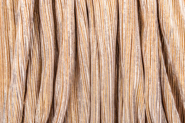 istock Golden shiny striped fabric, abstract background. 1191268167