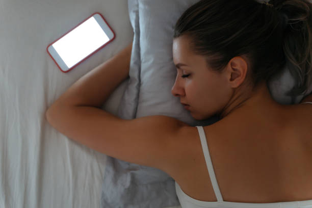 istock Mobile phone lying near sleeping woman. 1191268298