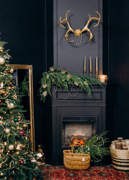 istock fireplace Christmas tree deer horns Golden black 1191269180