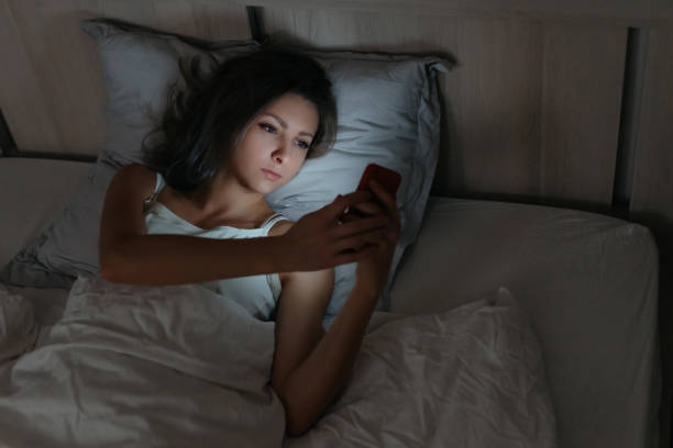 istock Female using smartphone in bed at night. 1191269646