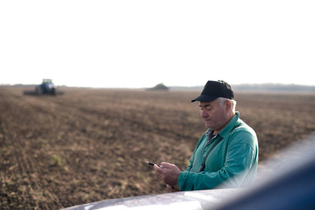 istock Farmer with tablet in field 1191270427