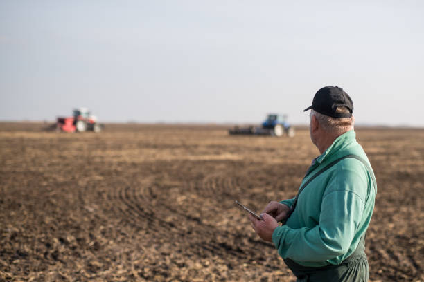 istock Farmer with tablet in field 1191270431