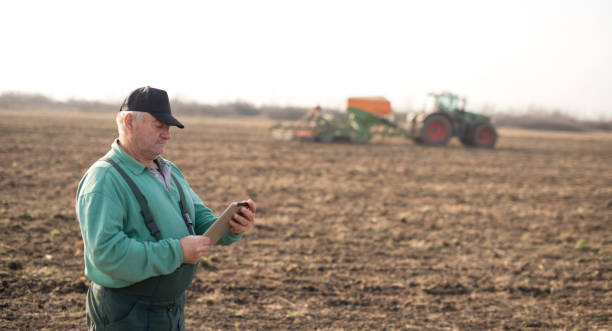 istock Modern senior farmer using tablet on the field Modern senior farmer using tablet on the field 1191270438