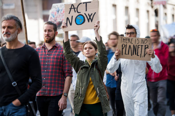 istock People with placards and protective suit on global strike for climate change. 1191271793