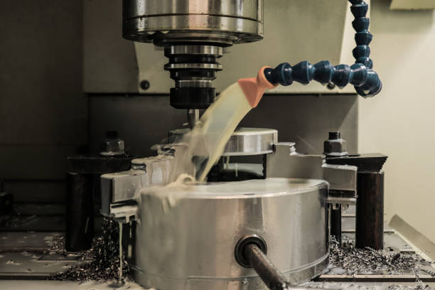 istock CNC milling machine processes the part and pours it with cutting fluid 1191271829