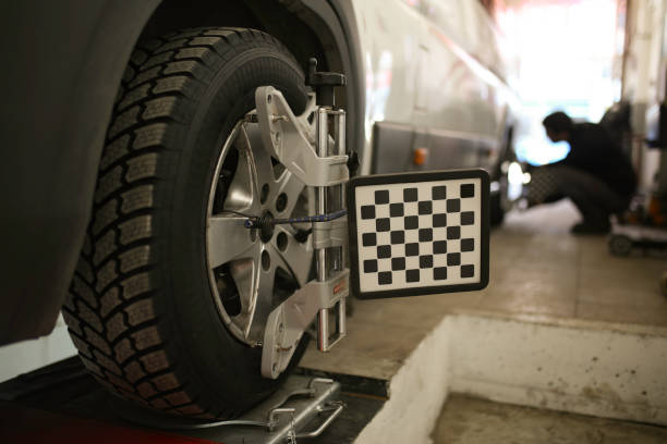 istock auto mechanic sets the car for diagnostics and configuration. Wheel alignment equipment on a car wheel in a repair station.3d tie rod balancing 1191271882