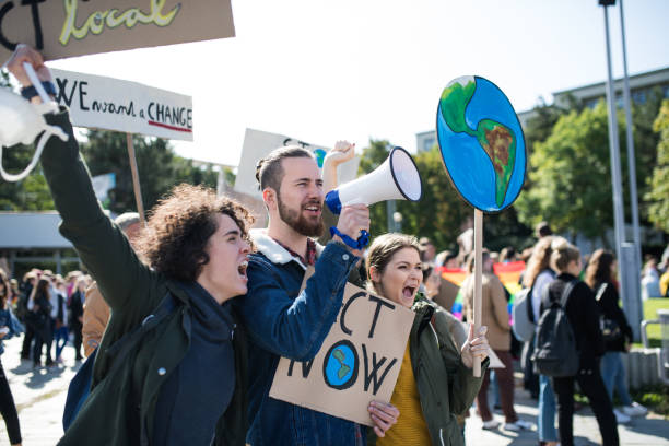 istock People with placards and amplifier on global strike for climate change. 1191272003