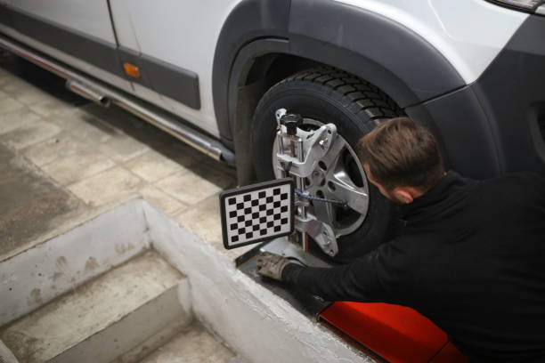 istock auto mechanic sets the car for diagnostics and configuration. Wheel alignment equipment on a car wheel in a repair station.3d tie rod balancing 1191272226
