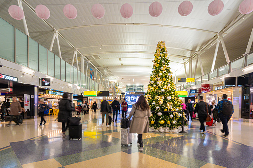 New York, November 2019: Christmas tree and holiday decorations in terminal 4 at the John F. Kennedy International Airport or JFK