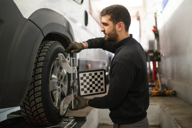 istock auto mechanic sets the car for diagnostics and configuration. Wheel alignment equipment on a car wheel in a repair station.3d tie rod balancing 1191275265