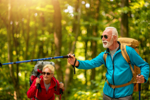 istock Happy senior couple walking together in a forest 1191277667