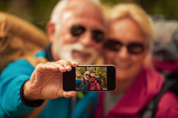 istock Happy senior couple walking together in a forest 1191277705