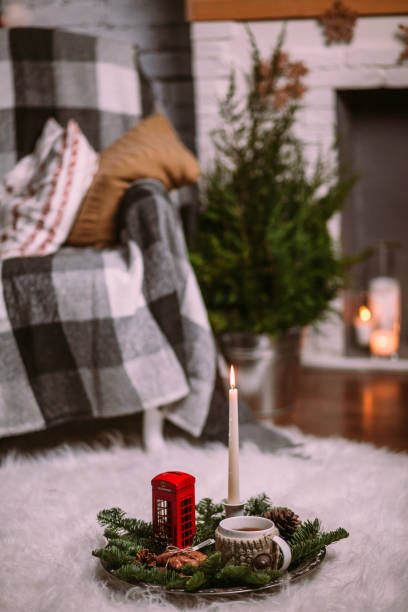 istock A cup of hot herbal tea on an iron tray decorated with Christmas tree branches, burning candles, cones, cookies, toys. Christmas background. New Year mood. 1191278426