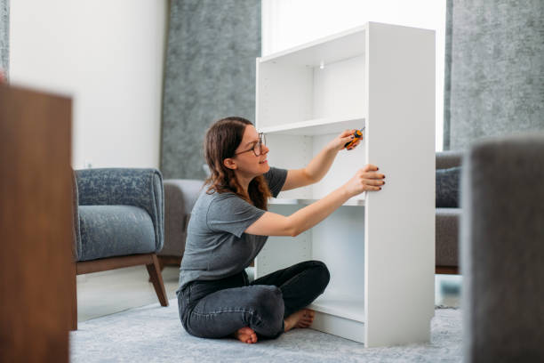 istock Woman Assembling Wooden Cabinet in Home 1191281232