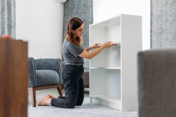 istock Woman Assembling Wooden Cabinet in Home 1191281310