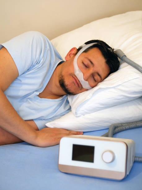 istock man wearing under the nose nasal mask and using Cpap machine for sleeping 1191282564