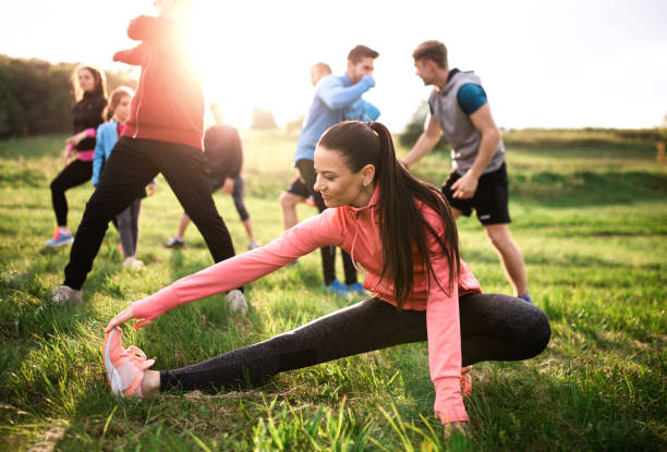 istock Large group of fit and active people doing exercise in nature, stretching. 1191282735