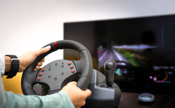 istock child playing racing on computer with steering wheel joystick 1191284813