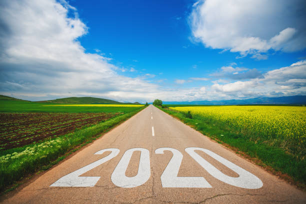 istock Concept for 2020.Driving on an empty asphalt road at beautiful sunny day 1191284960