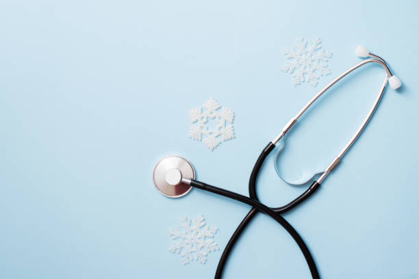 istock Stethoscope on light blue background with snowflakes, copy space. winter medicine card 1191287064