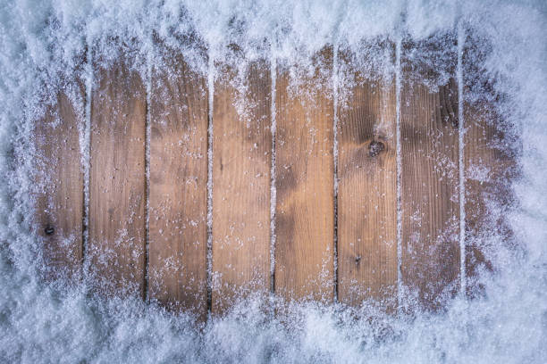 istock Wooden table covered with snow as frame 1191287065